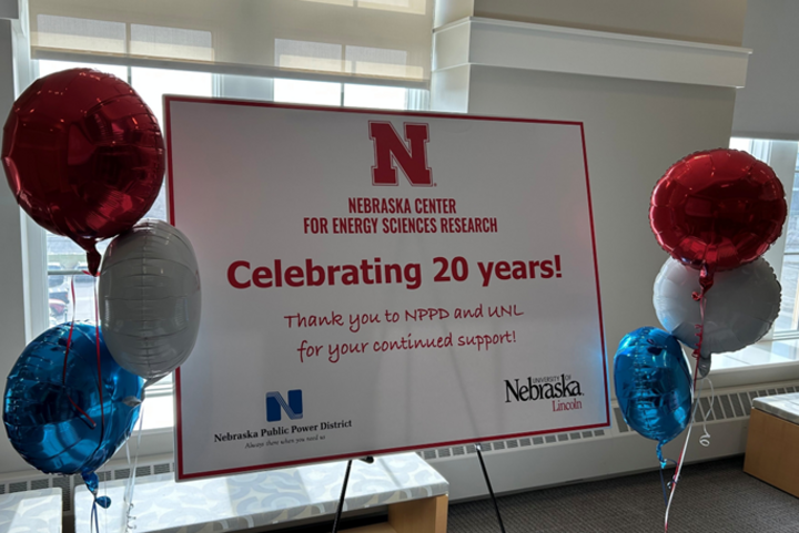 Celebratory sign with balloons marking 20 years of the Nebraska Center for Energy Sciences Research.